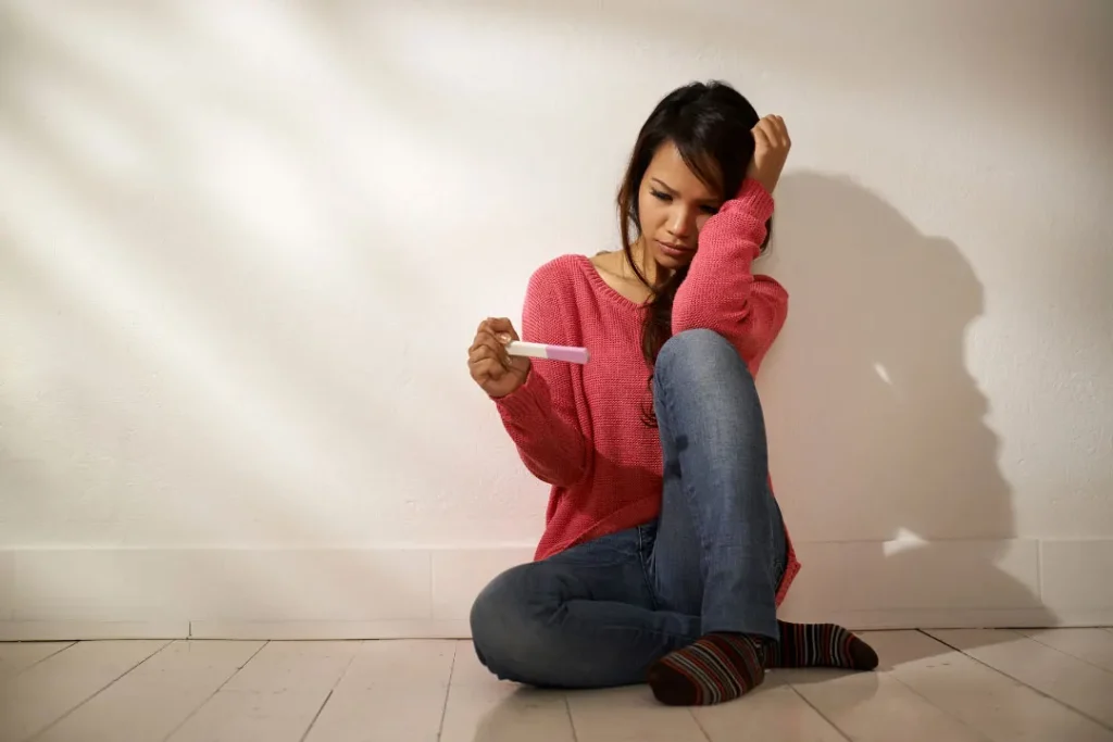 A lady watching the pregnancy stick. 